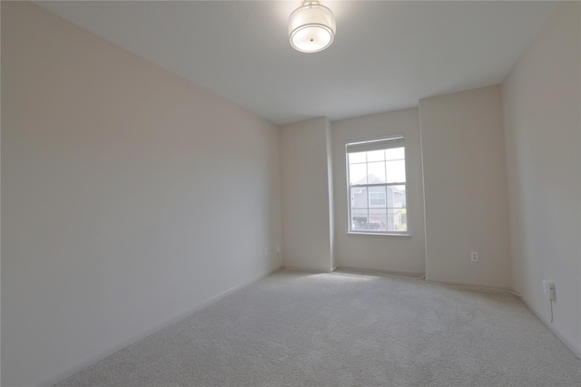 spare room with light colored carpet