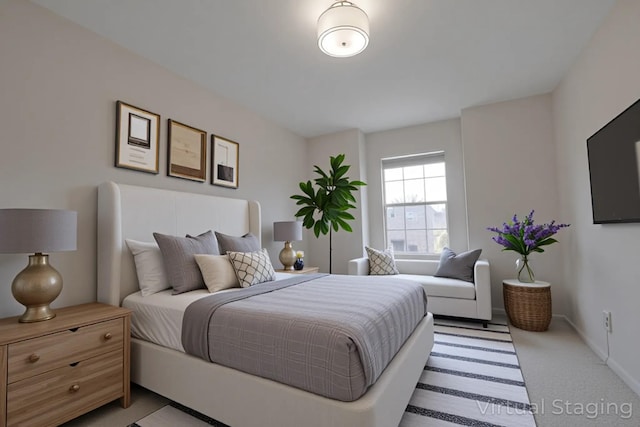 bedroom featuring light colored carpet and baseboards