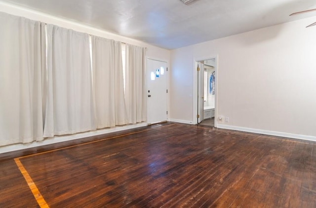 interior space featuring baseboards, ceiling fan, and hardwood / wood-style floors