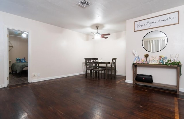 unfurnished dining area with baseboards, ceiling fan, visible vents, and hardwood / wood-style flooring