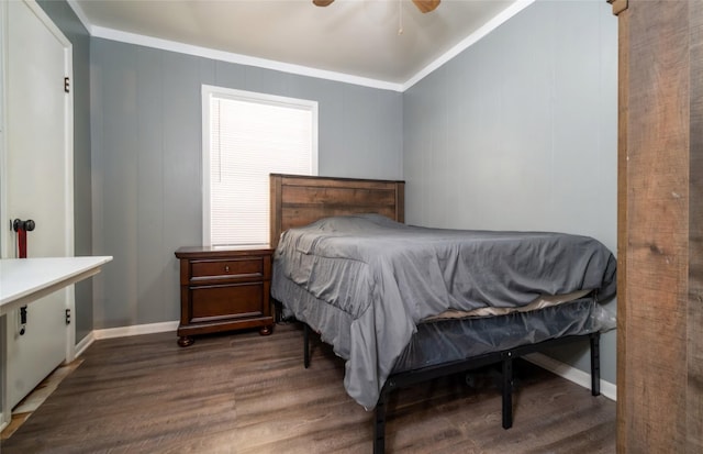 bedroom with baseboards, wood finished floors, ornamental molding, and a ceiling fan