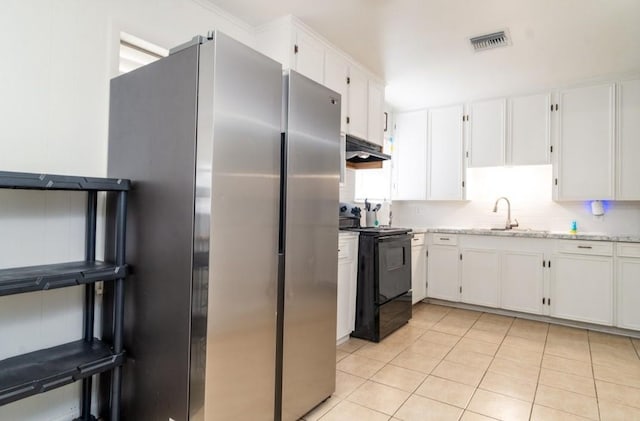 kitchen with visible vents, under cabinet range hood, white cabinetry, electric range, and freestanding refrigerator