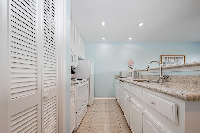 9520 Seawall Blvd Unit 126, Galveston, TX 77554 - kitchen with a sink, white appliances, white cabinetry, recessed lighting, and light tile patterned flooring