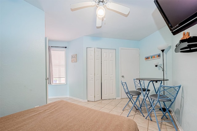 9520 Seawall Blvd Unit 126, Galveston, TX 77554 - bedroom featuring a closet, light tile patterned flooring, baseboards, and a ceiling fan
