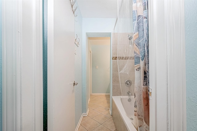 9520 Seawall Blvd Unit 126, Galveston, TX 77554 - full bathroom featuring tile patterned floors, shower / tub combo with curtain, and baseboards