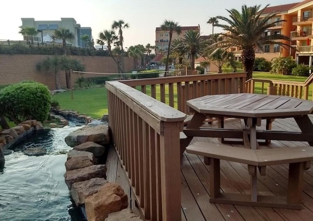 9520 Seawall Blvd Unit 126, Galveston, TX 77554 - wooden deck featuring a yard and outdoor dining space