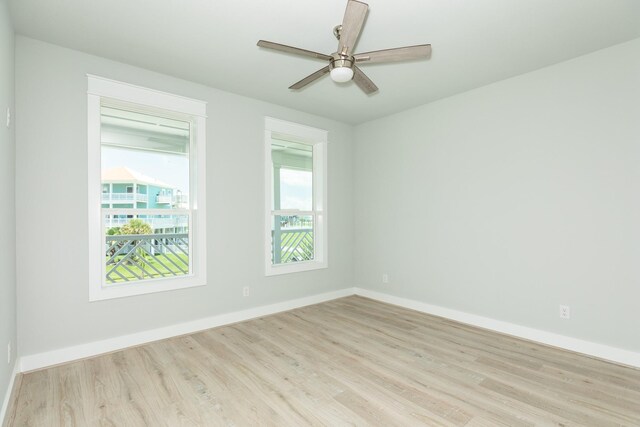 18821 Warrior Rd, Galveston, TX 77554 - unfurnished room with wood finished floors, baseboards, and a ceiling fan