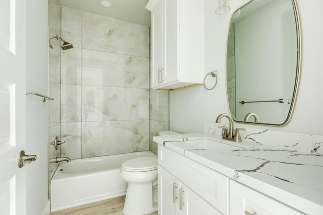 18821 Warrior Rd, Galveston, TX 77554 - bathroom featuring vanity, toilet, washtub / shower combination, and wood finished floors