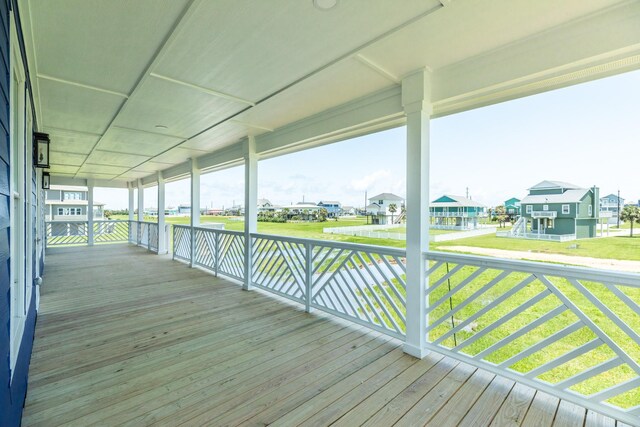 18821 Warrior Rd, Galveston, TX 77554 - wooden terrace with a residential view and a lawn