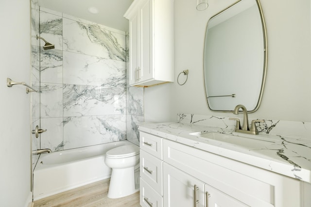 18821 Warrior Rd, Galveston, TX 77554 - bathroom with vanity, washtub / shower combination, toilet, and wood finished floors