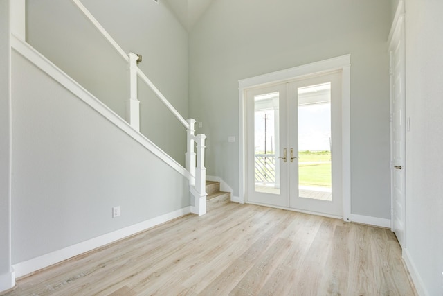 18821 Warrior Rd, Galveston, TX 77554 - entryway featuring french doors, wood finished floors, stairway, and baseboards