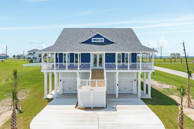 18821 Warrior Rd, Galveston, TX 77554 - raised beach house featuring roof with shingles, an attached garage, and driveway
