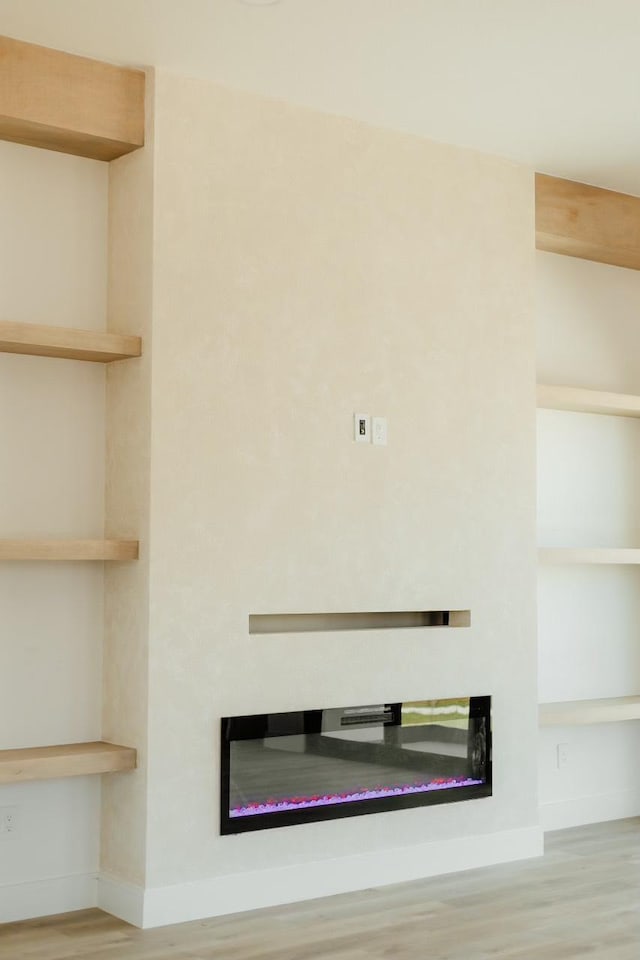 2805 Delano St, Houston, TX 77004 - detailed view of a glass covered fireplace and wood finished floors