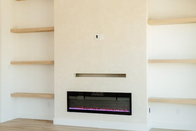 2805 Delano St, Houston, TX 77004 - detailed view of a glass covered fireplace and wood finished floors