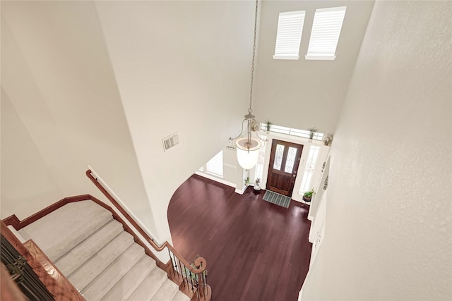 3730 Arundel Gardens Ln, Sugar Land, TX 77498 - entryway with a towering ceiling, wood finished floors, stairway, and baseboards