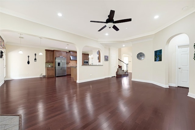 3730 Arundel Gardens Ln, Sugar Land, TX 77498 - unfurnished living room featuring a ceiling fan, arched walkways, dark wood-style flooring, baseboards, and recessed lighting