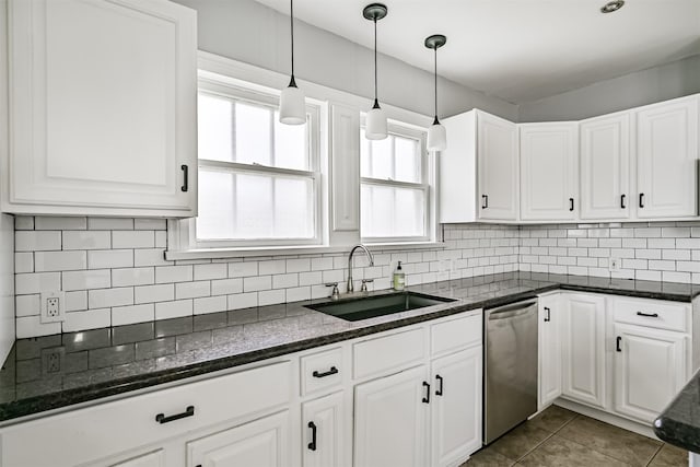 kitchen with stainless steel dishwasher, white cabinetry, decorative backsplash, and a sink