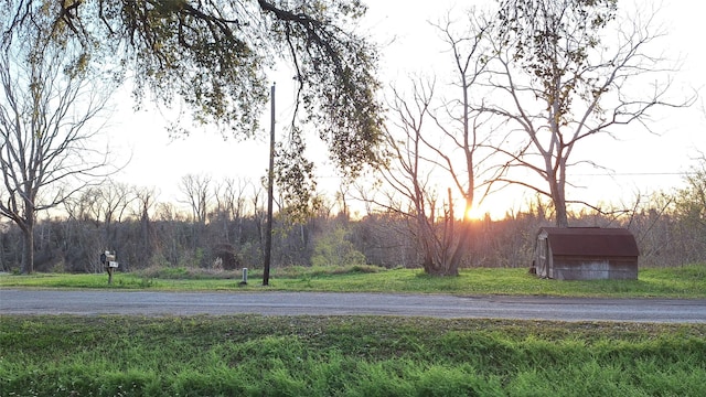 view of street featuring a forest view