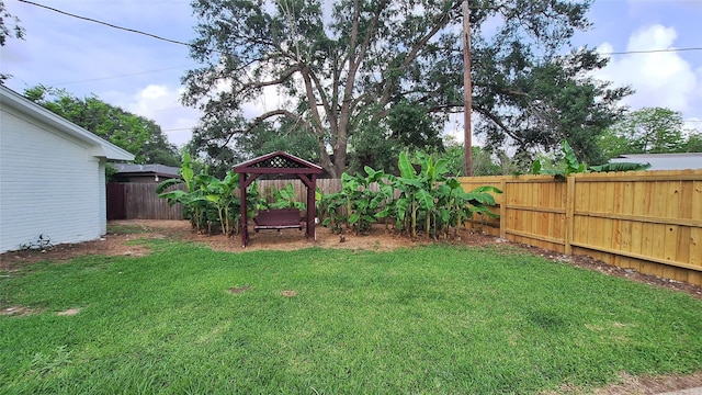 view of yard featuring a gazebo and a fenced backyard