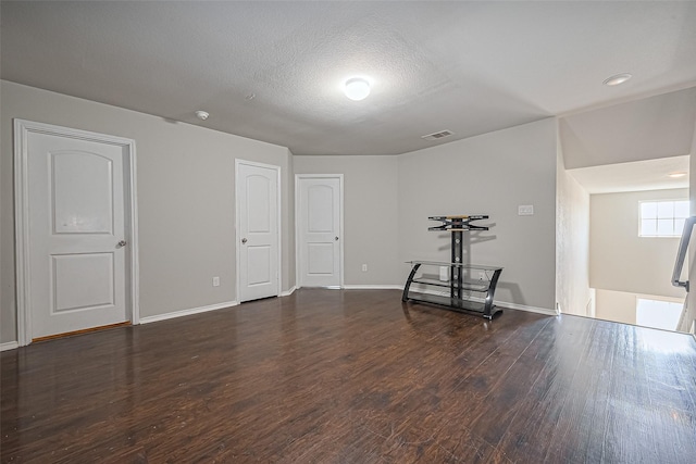 5407 Matilda Bend Ln, Katy, TX 77449 - interior space featuring a textured ceiling, baseboards, visible vents, and wood finished floors