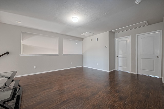 5407 Matilda Bend Ln, Katy, TX 77449 - unfurnished living room with a textured ceiling, attic access, baseboards, and dark wood finished floors