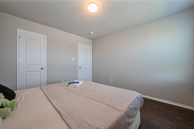 5407 Matilda Bend Ln, Katy, TX 77449 - bedroom with baseboards and dark wood-style floors