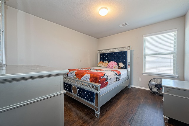 5407 Matilda Bend Ln, Katy, TX 77449 - bedroom with visible vents, dark wood-style flooring, and baseboards