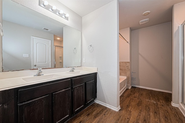 5407 Matilda Bend Ln, Katy, TX 77449 - bathroom with a sink, visible vents, and wood finished floors