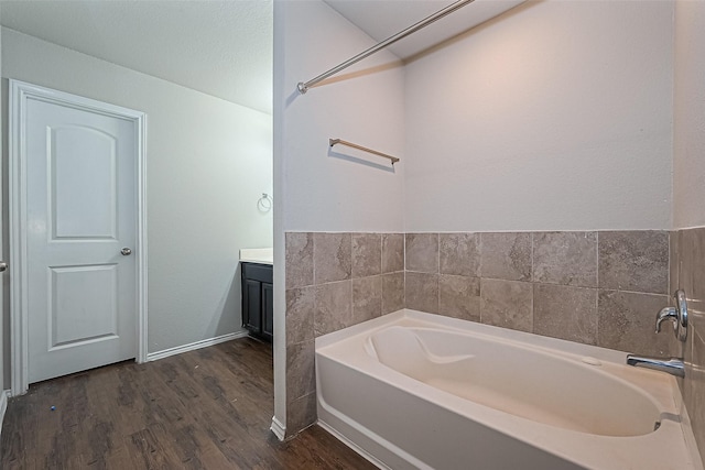5407 Matilda Bend Ln, Katy, TX 77449 - bathroom featuring baseboards, a garden tub, vanity, and wood finished floors