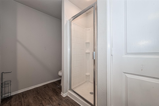 5407 Matilda Bend Ln, Katy, TX 77449 - bathroom featuring a stall shower, baseboards, toilet, and wood finished floors