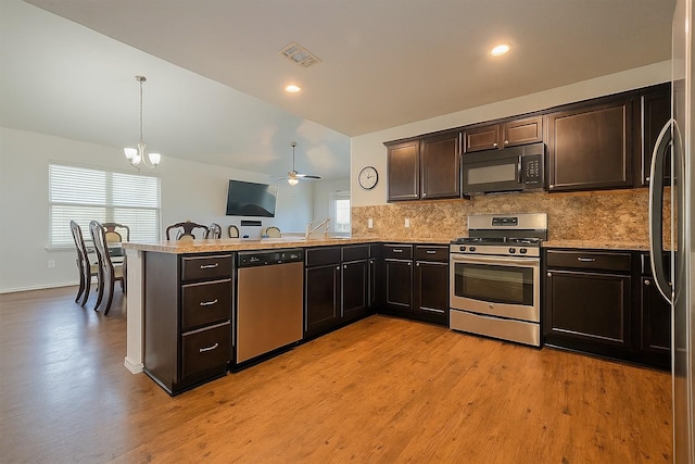 5407 Matilda Bend Ln, Katy, TX 77449 - kitchen featuring plenty of natural light, appliances with stainless steel finishes, visible vents, and backsplash