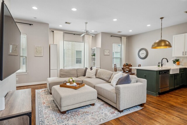 living area with recessed lighting, baseboards, visible vents, ceiling fan, and dark wood-style floors
