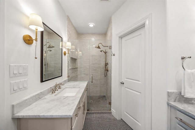 bathroom with a stall shower, vanity, and tile patterned flooring