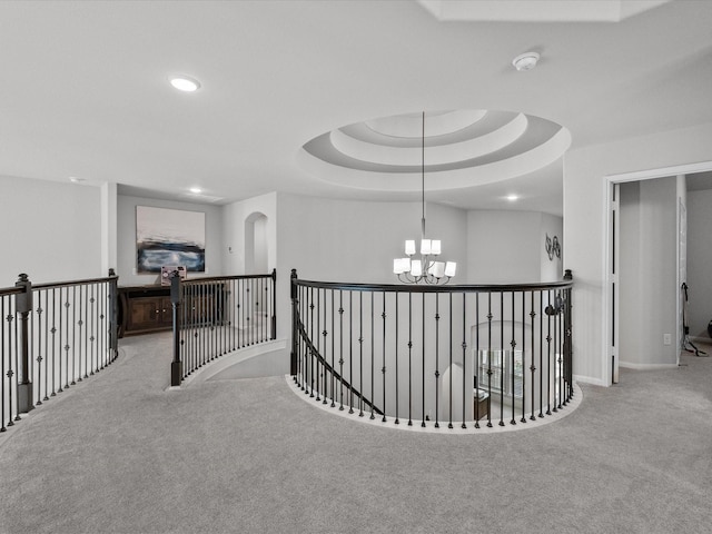 2712 Ahnya Ln, League City, TX 77573 - corridor featuring a notable chandelier, an upstairs landing, carpet floors, a raised ceiling, and recessed lighting
