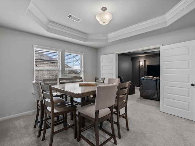 2712 Ahnya Ln, League City, TX 77573 - dining room featuring light colored carpet, ornamental molding, baseboards, a raised ceiling, and visible vents