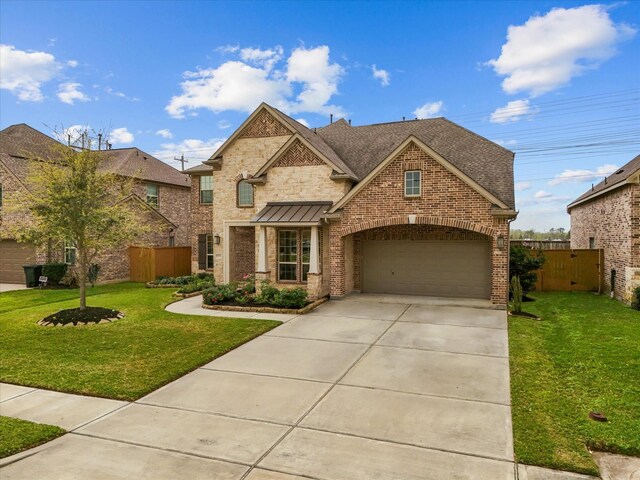 2712 Ahnya Ln, League City, TX 77573 - view of front of property with driveway, fence, brick siding, a front lawn, and a garage