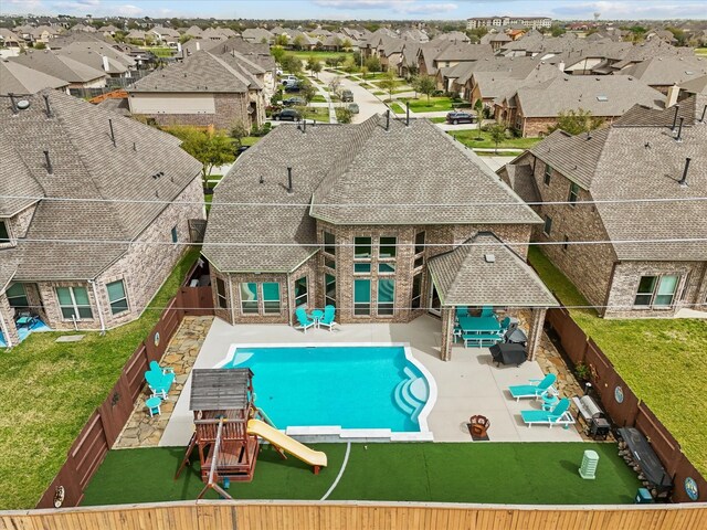 2712 Ahnya Ln, League City, TX 77573 - view of pool featuring a patio, a fenced backyard, a lawn, and a residential view