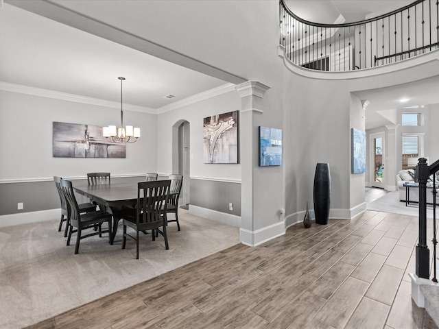2712 Ahnya Ln, League City, TX 77573 - dining space with baseboards, wood finished floors, ornamental molding, and an inviting chandelier