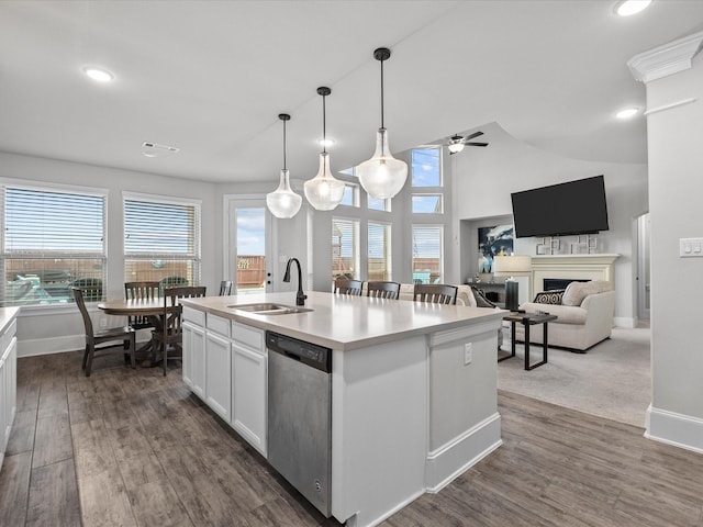 2712 Ahnya Ln, League City, TX 77573 - kitchen featuring a sink, a ceiling fan, a fireplace, stainless steel dishwasher, and dark wood-style floors