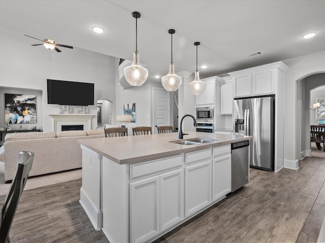 2712 Ahnya Ln, League City, TX 77573 - kitchen featuring stainless steel appliances, a sink, arched walkways, visible vents, and a ceiling fan