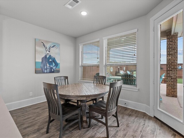 2712 Ahnya Ln, League City, TX 77573 - dining space with baseboards, visible vents, and wood finished floors