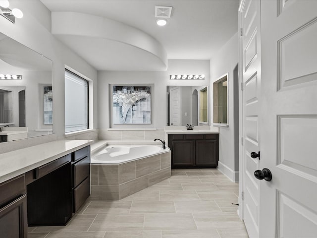 2712 Ahnya Ln, League City, TX 77573 - full bath with visible vents, two vanities, a sink, and a garden tub
