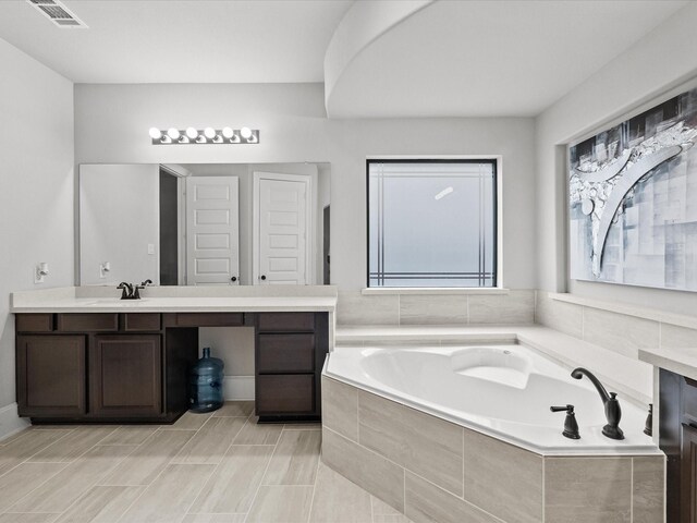 2712 Ahnya Ln, League City, TX 77573 - bathroom featuring vanity, a garden tub, and visible vents