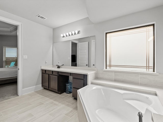 2712 Ahnya Ln, League City, TX 77573 - full bathroom featuring vanity, a garden tub, ensuite bathroom, baseboards, and visible vents