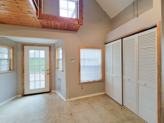 810 E 28th St, Houston, TX 77009 - doorway to outside featuring light tile patterned flooring, baseboards, and vaulted ceiling