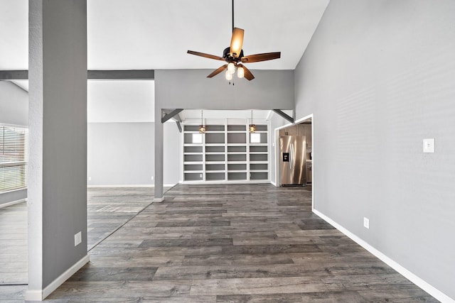 unfurnished living room with baseboards, wood finished floors, and a ceiling fan
