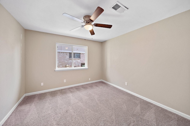 empty room with baseboards, carpet flooring, visible vents, and a ceiling fan