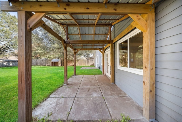 view of patio with a fenced backyard, an outdoor structure, and a shed