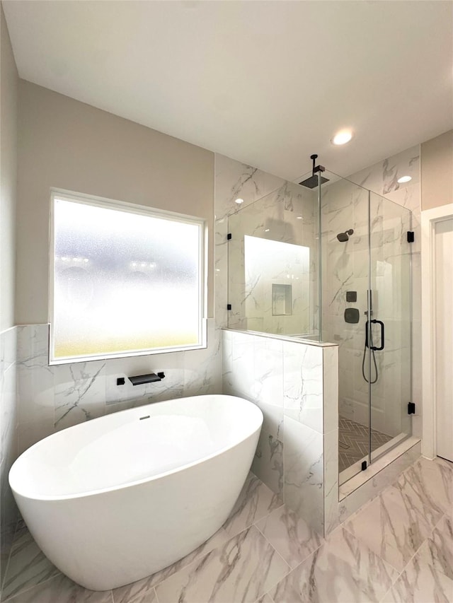 635 Lily St, Prairie View, TX 77484 - bathroom with a soaking tub, a marble finish shower, tile walls, marble finish floors, and recessed lighting