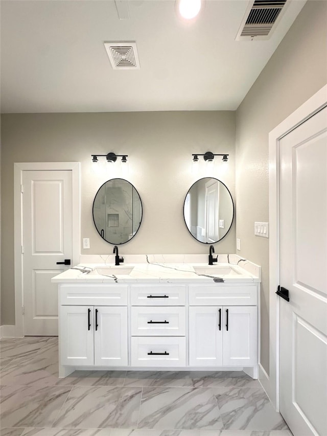 635 Lily St, Prairie View, TX 77484 - bathroom with marble look tiles, double vanity, and baseboards